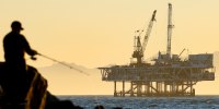 A person fishes with offshore oil and gas platform in California. 
